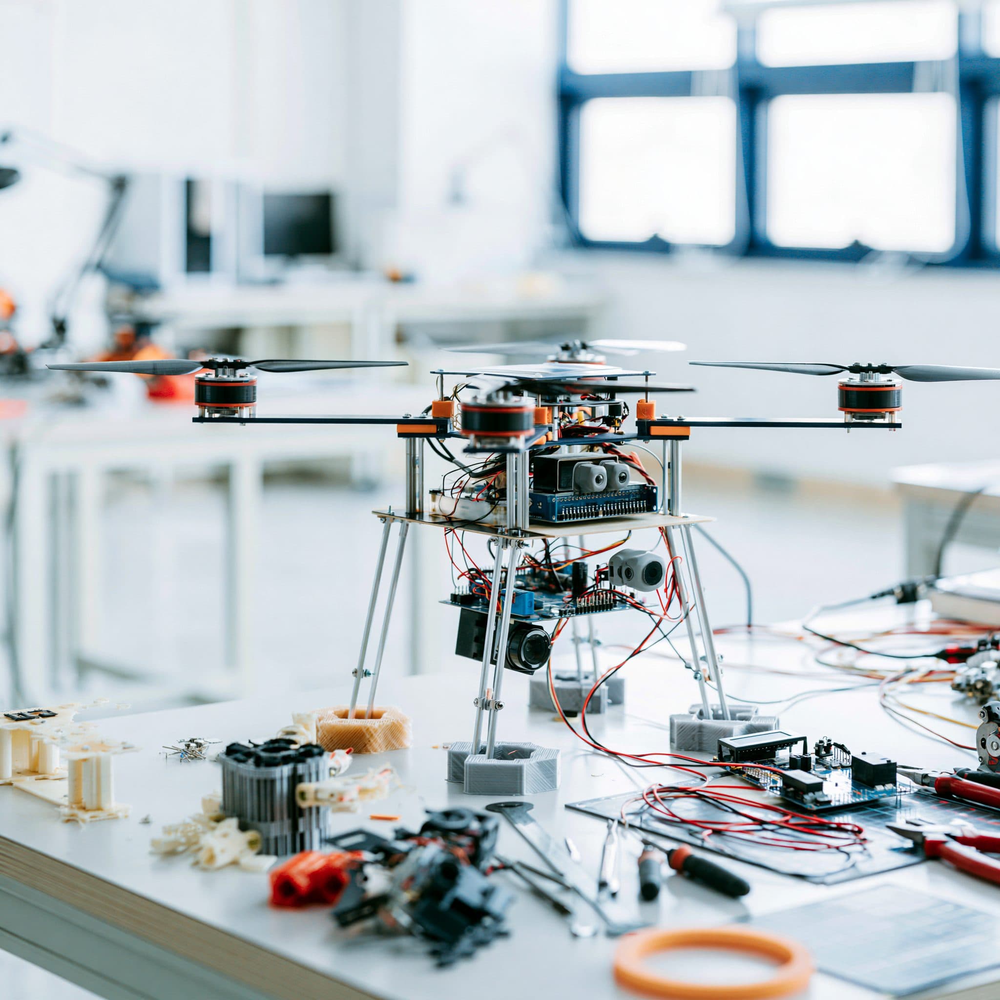 Drone prototype on a lab bench with wiring and printed parts