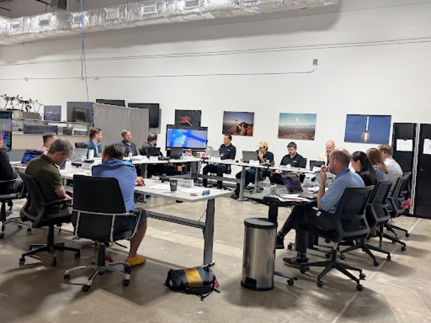 An open engineering floor, desks with dual monitors and people working at them
